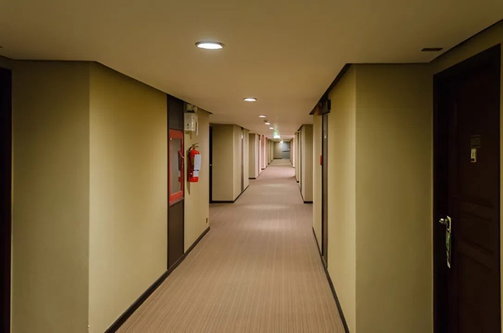 Condo building hallway with neutral wall finishes by an interior painter in Waipahu, HI