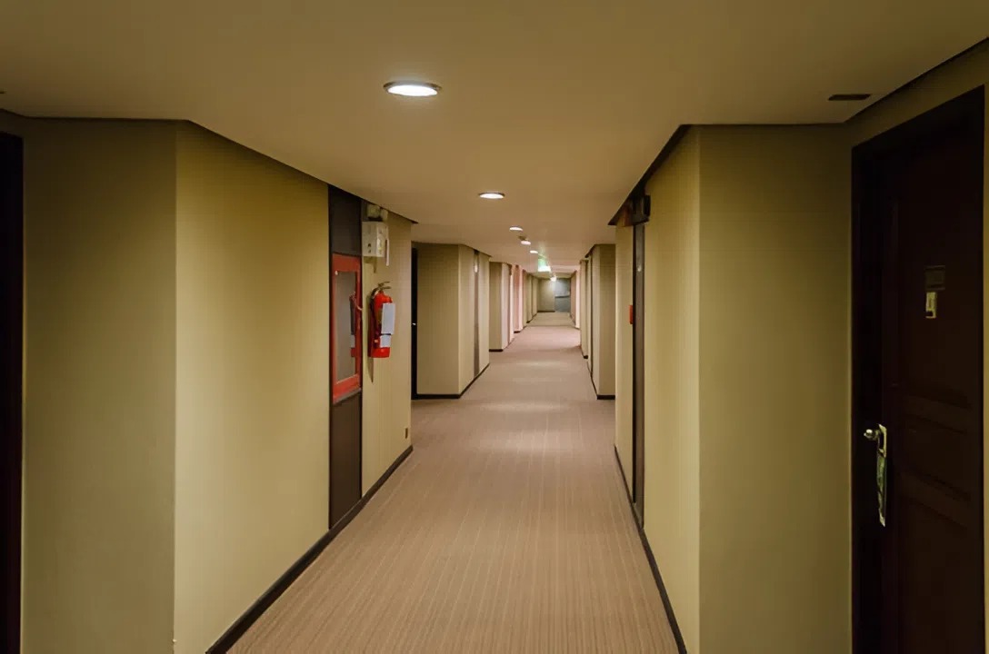 Condo building hallway with neutral wall finishes by an interior painter in Waipahu, HI