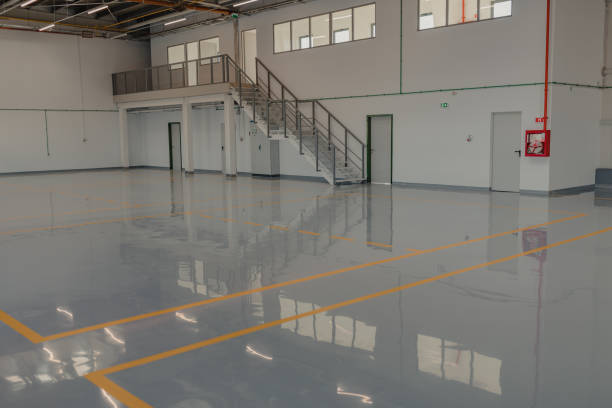 Industrial warehouse with polished gray epoxy flooring and clean interior finished by a painting company in Hawaii Kai, HI